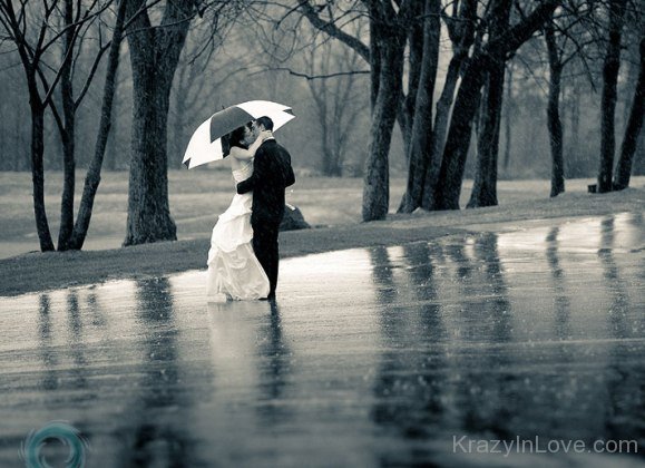 Sweet Couple Standing In Rain